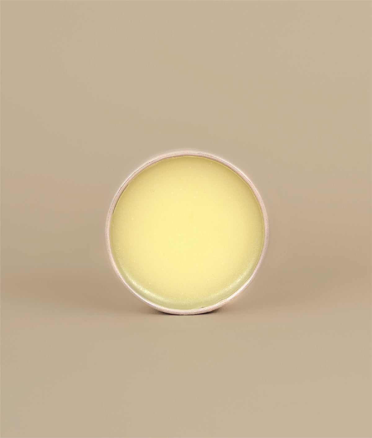 Circular Face lotion on its side showing what lotion looks like