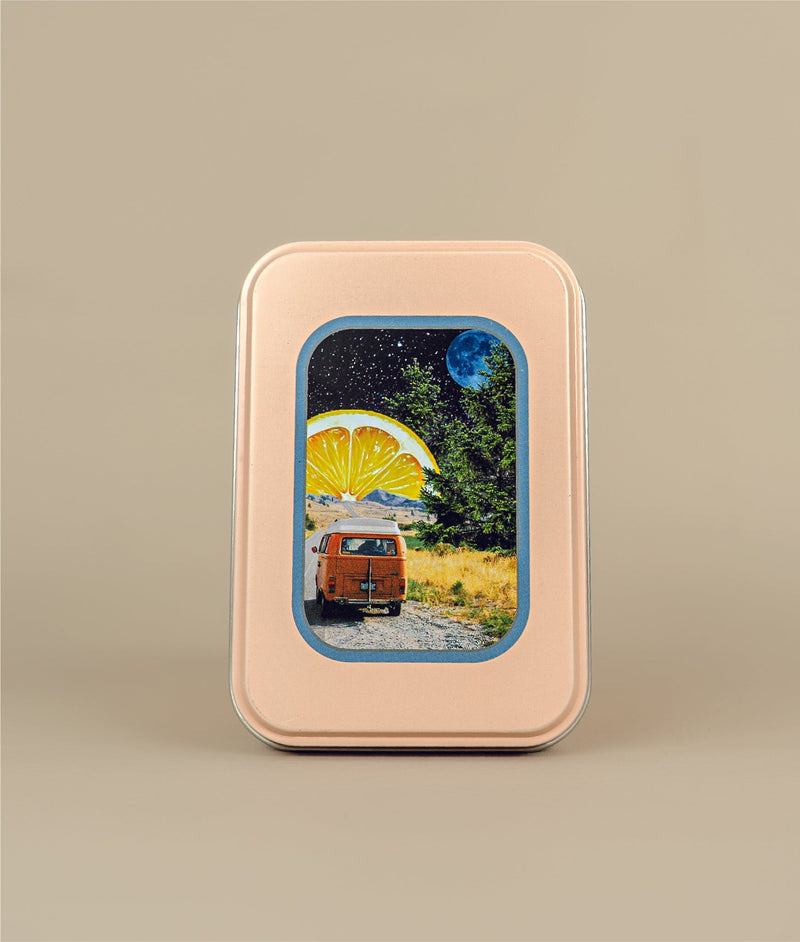 Image of travel tin with image of sleeper van with cedar trees and a lemon