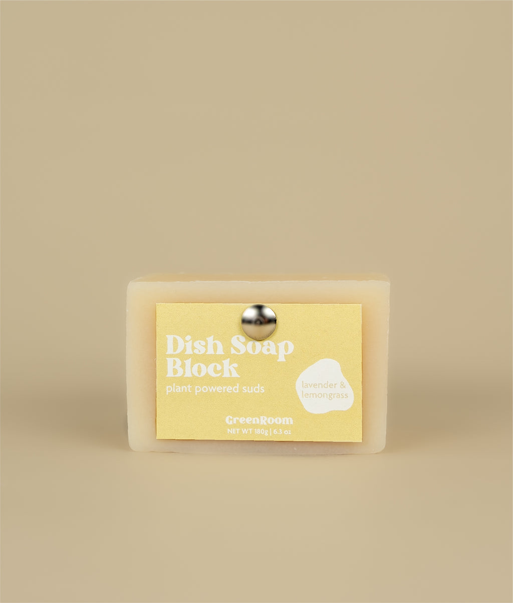 Yellow dish soap block with recycled paper tag held up by a metal thumb tac