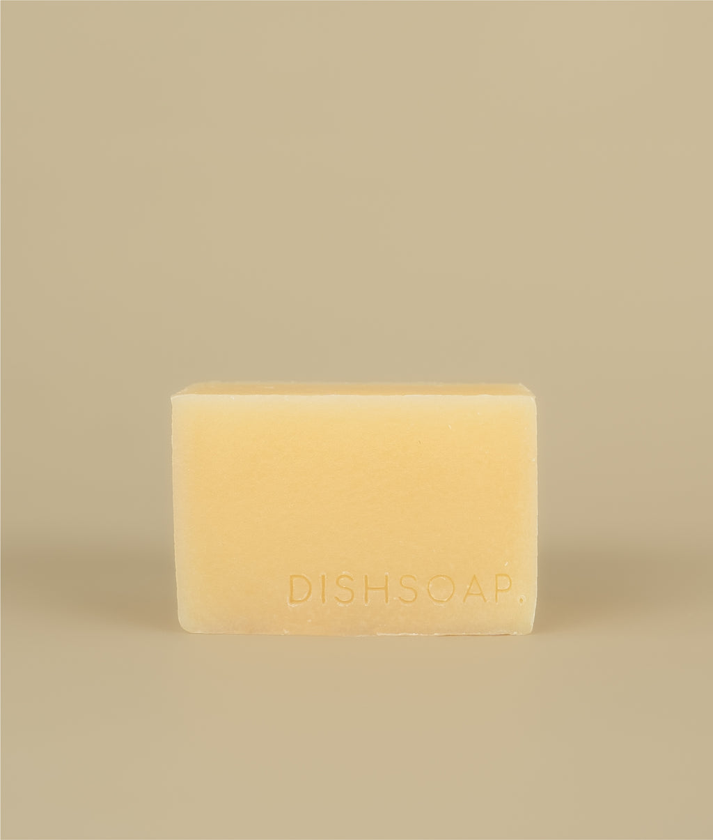 Yellow dish soap stamped with the word DISH SOAP in the bottom right corner