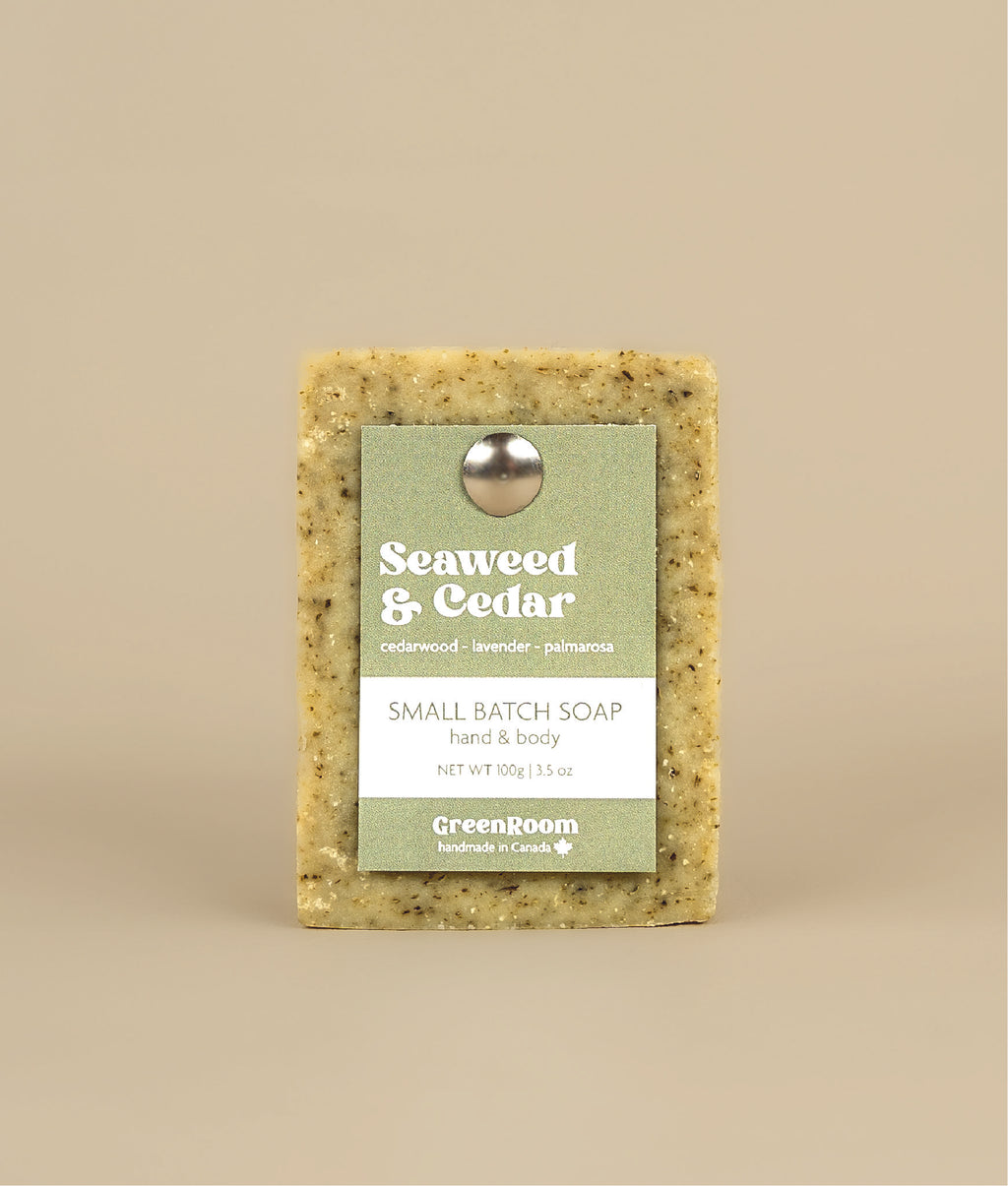 Seaweed and cedar soap with green and white recycled paper tag held up by metal push pin