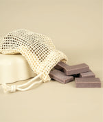 Meshed soap saver bag dumping dumping small cut offs of lavender zinc soap 