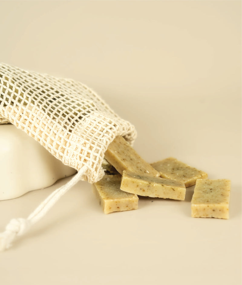 Meshed soap saver bag dumping dumping small cut offs of seaweed and cedar soap 