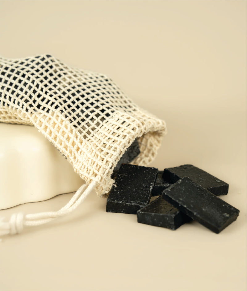 Meshed soap saver bag dumping dumping small cut offs of charcoal and clay soap