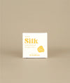 White with yellow writing small square sunny silk conditioner bar packaging